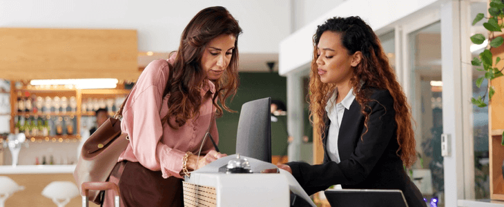 a woman checks into a hotel