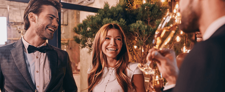 a bride and groom speak to a guest